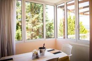 a room with windows and a table with a candle at LULA 'S HOUSE in Iraklitsa