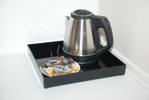 a tea kettle in a black box on a counter at Elxis Luxury Resort in Nea Vrasna