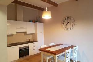 a kitchen with a table and a clock on the wall at Villetta Volta in Rapallo