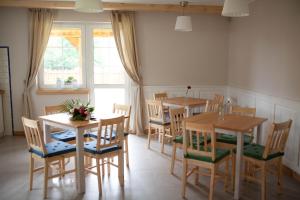a dining room with two tables and chairs at Mazurska Gajówka in Ruciane-Nida +53 photos