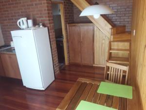 a kitchen with a white refrigerator and a staircase at Posada de los Árboles in Eldorado