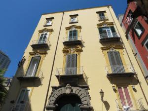 a yellow building with balconies on a street at Olimpo degli Dei in Naples