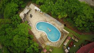 an overhead view of a swimming pool with a plane in it at Magnific Rock - Surf Resort & Yoga Retreat Nicaragua in Popoyo