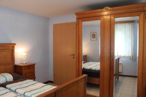 a small bedroom with two beds and a closet at FILD - Holiday Apartment in Saint-Vith