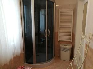 a glass shower in a bathroom with a trash can at Appartamento cuore al centro di Taranto in Taranto