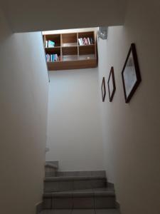 a staircase with three pictures on a white wall at Appartamento Arzachena Costa Smeralda in Arzachena