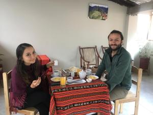 a man and a woman sitting at a table at Hostal Apu Qhawarina - Ollantaytambo in Ollantaytambo +74 photos
