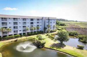 a building with a lake in front of a building at Hilton Head Resort in Hilton Head Island
