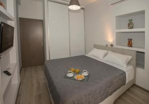 A bed or beds in a room at Acropolis Gem by GHH
