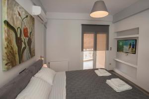 A bed or beds in a room at Acropolis Gem by GHH