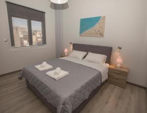A bed or beds in a room at Acropolis Gem by GHH