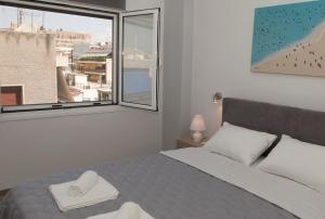 A bed or beds in a room at Acropolis Gem by GHH