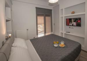 A bed or beds in a room at Acropolis Gem by GHH