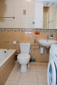 a bathroom with a toilet and a sink at ApartamentyPrzyMorzu Reymonta z sypialnią in Kołobrzeg