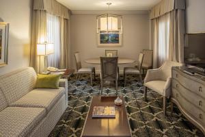 a living room with a couch and a table at Bell Tower Hotel in Ann Arbor