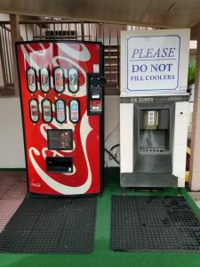 a coca cola vending machine next to a soda machine at Executive Inn in Pensacola