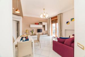 a living room with a table and a red couch at Belvedere Apartment in Amalfi