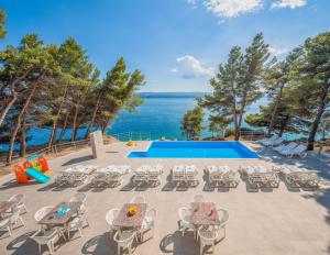 a patio with chairs and a swimming pool at Villa Charlotte in Omiš