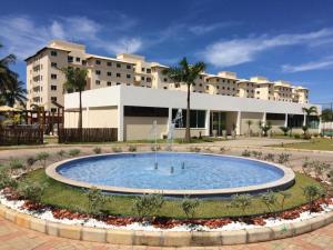 a large swimming pool in front of a building at Conforto - VOG Torres do Sul Ilhéus in Ilhéus