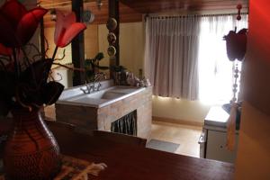 a kitchen with a brick fireplace with a sink at Loft São Joaquim in São Joaquim