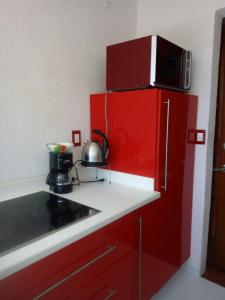 a kitchen with red cabinets and a red refrigerator at punta sam in front isla mujeres in Cancún