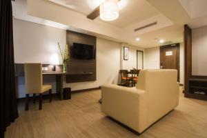 a living room with a couch and a table and chairs at Pandawa Hill Resort in Nusa Dua