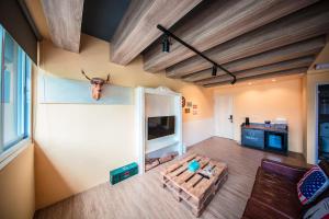 a living room with a table and a tv at Urban in Kaohsiung