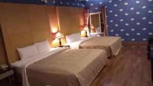 Postel nebo postele na pokoji v ubytování Treasure Island Motel - Fengshan