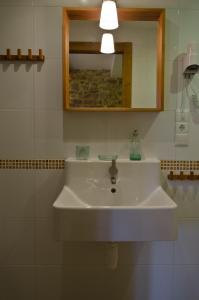 a white sink in a bathroom with a mirror at Apartamentos Playa Galizano in Galizano