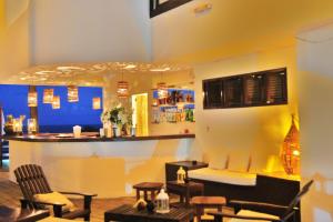 a bar with chairs and a counter in a room at Agora Pousada e Bar in Pipa