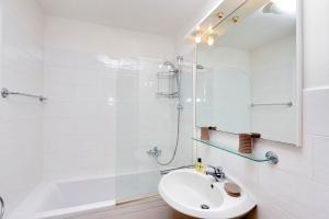 a white bathroom with a sink and a shower at Agriturismo Pimpinnacolo in Porto Ercole +37 photos