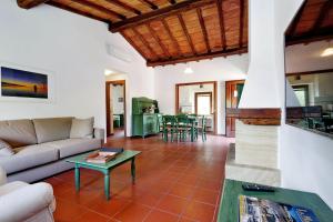 a living room with a couch and a table at Agriturismo Pimpinnacolo in Porto Ercole