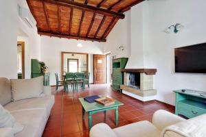 a living room with a couch and a fireplace at Agriturismo Pimpinnacolo in Porto Ercole