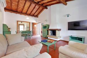 a living room with a couch and a fireplace at Agriturismo Pimpinnacolo in Porto Ercole