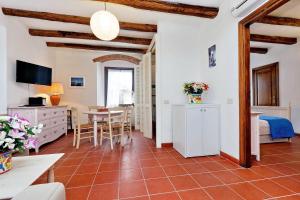a room with a bedroom and a dining room at Agriturismo Pimpinnacolo in Porto Ercole