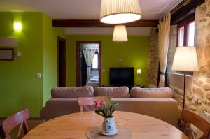 a living room with a couch and a table at Apartamentos Playa Galizano in Galizano