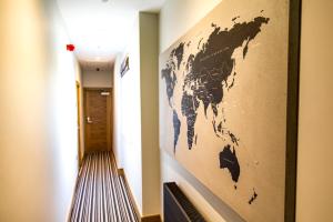 a map of the world on a wall in a hallway at The Hugo - Hotel Concept Canterbury in Canterbury