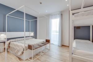 a bedroom with two bunk beds and a mirror at Evo Boutique Hotel & SPA in Bellaria-Igea Marina