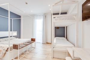 a bedroom with two bunk beds and a desk at Evo Boutique Hotel & SPA in Bellaria-Igea Marina +161 photos