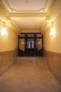 an empty hallway with a door and stairs at Hostal Zamorán in Madrid