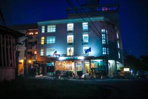 a tall building with lights on it at night at Tchero Hotel in Douala