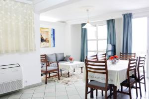 a kitchen and dining room with a table and chairs at Tchero Appartement 1 in Douala
