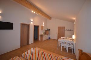 a living room with a table and a dining room at FeWo Weisweil in Weisweil