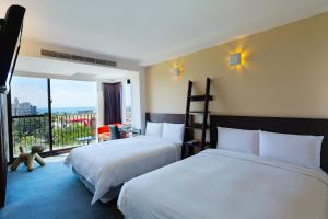 Ένα ή περισσότερα κρεβάτια σε δωμάτιο στο Hotel Les Champs Hualien +70 φωτογραφίες