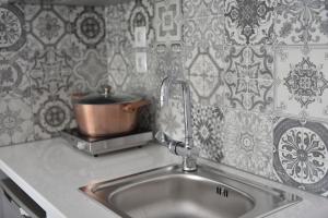a kitchen sink with a pot on top of it at Ilion Luxury Apartments in Asprovalta +17 photos