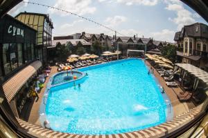 a view of a swimming pool from a window at Hotel Temernitskiy in Rostov on Don