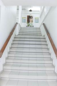 een trap in een gebouw met witte tegels bij Tchero Appartement 2 in Douala