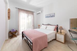 a bedroom with a bed and a chair and a window at Lilla Cozy House in Rhodes Town