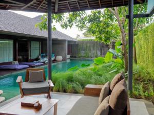 a living room with a pool in a house at The Santai by LifestyleRetreats in Canggu