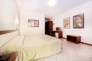 Postel nebo postele na pokoji v ubytování Hotel & Residence La Sibilla Cusiana